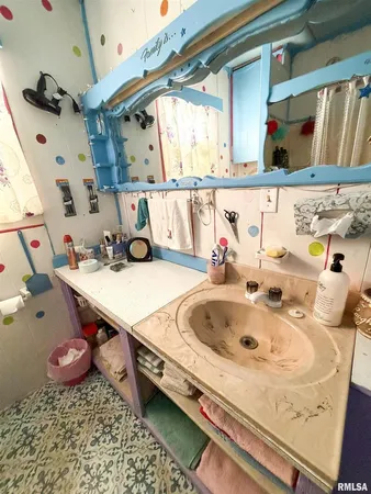 a bathroom with a sink and a window