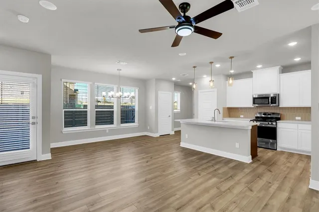 a view of kitchen with sink microwave and stove