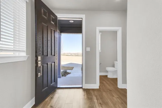 a view of a bathroom from a hallway