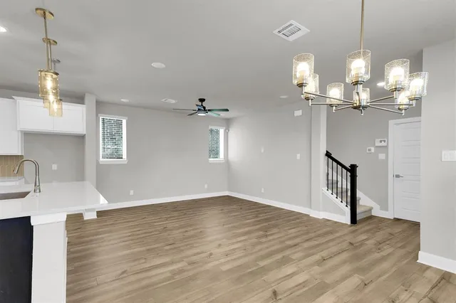 a view of a chandelier and wooden floor in living room