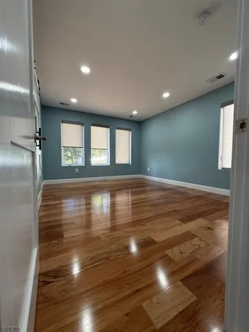 a view of hallway with stairs and a window