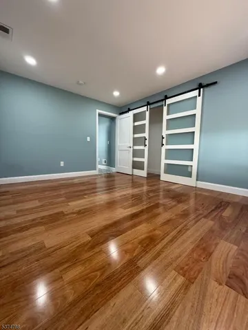 a view of wooden floor and windows in a room