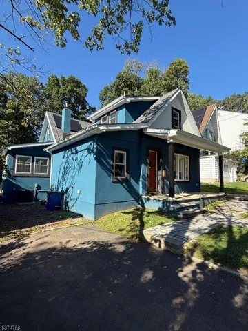 a view of a house with swimming pool in front of it