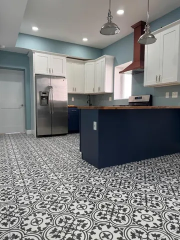 a kitchen with a sink a stove and cabinets