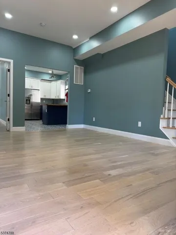 a view of room with wooden floor and window