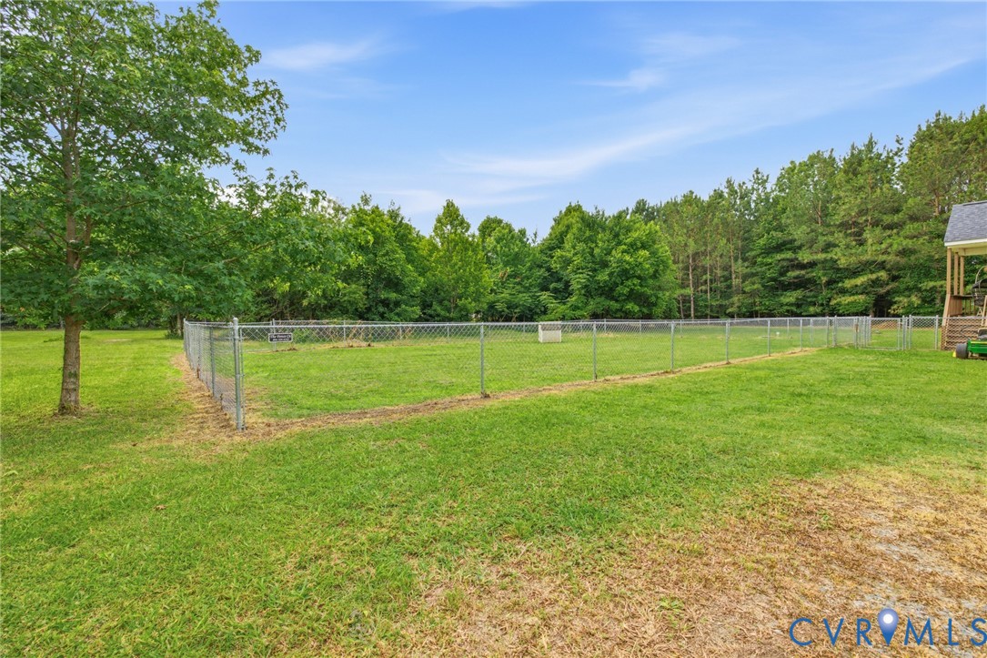 9433 Robin Road Disputanta, VA 23842 - Photo 25 of 26 Expansive green space featuring a large fenced are