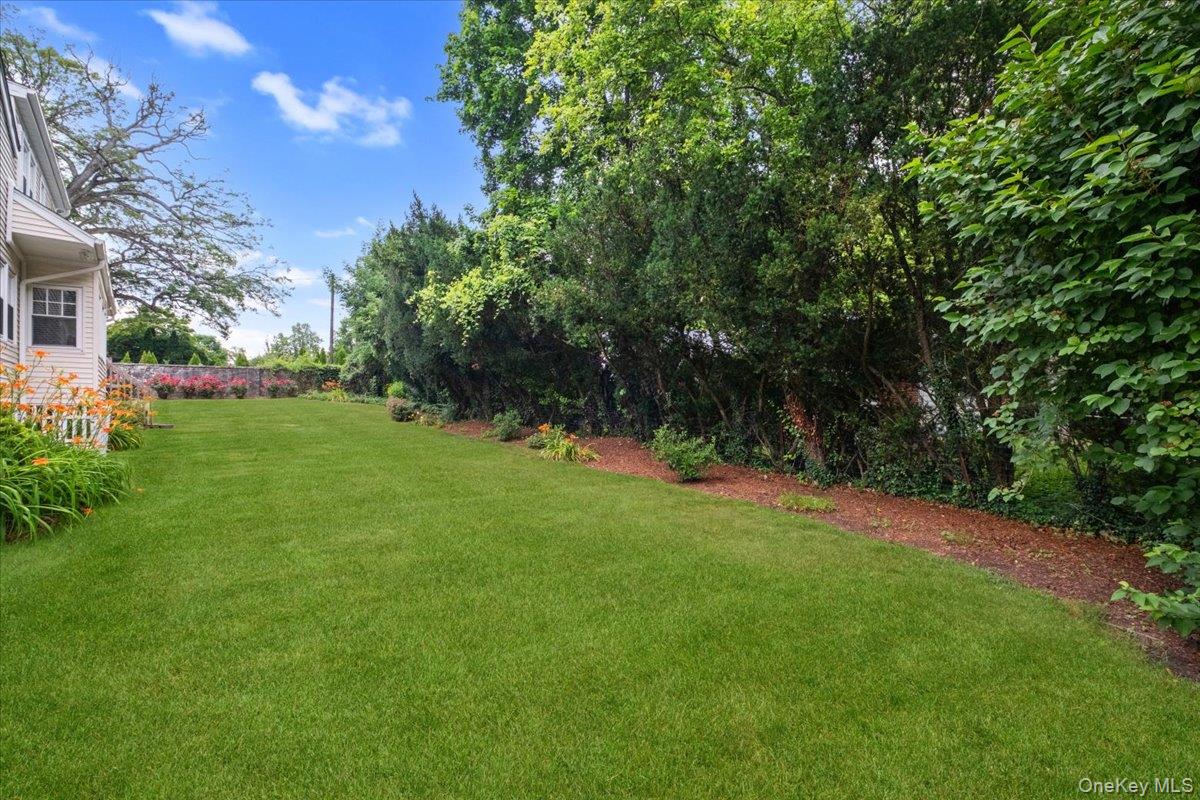 30 Stonehouse Road Scarsdale, NY 10583 - Photo 22 of 24 Pretty backyard with mature trees and plenty of lawn to have fun with friends and family.