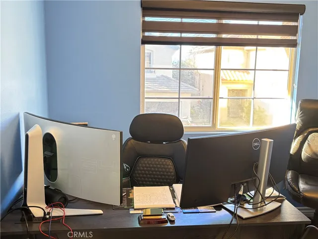 a bedroom with a bed window and a mirror