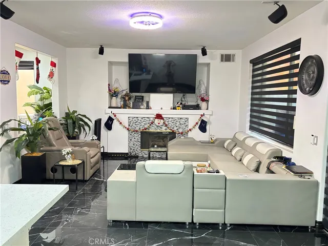 a view of living room with furniture and flowers