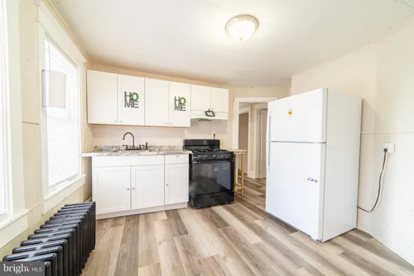 a kitchen with a refrigerator and a stove
