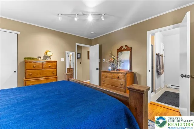 a view of a bedroom with furniture and window