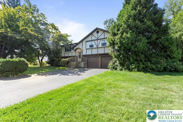 a front view of a house with garden