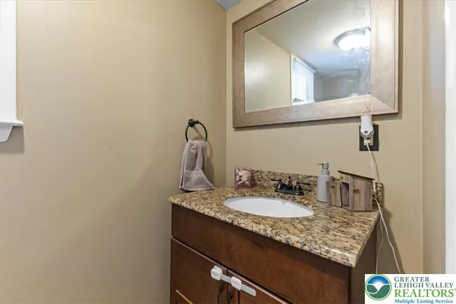 a bathroom with a sink vanity and a mirror