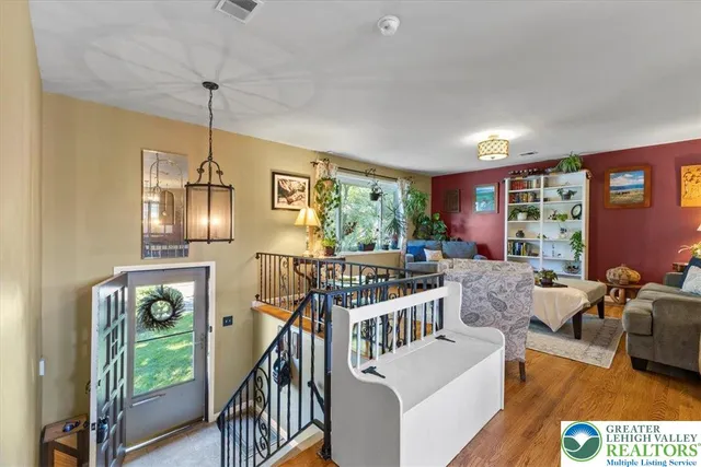 a view of a livingroom with furniture wooden floor chandelier