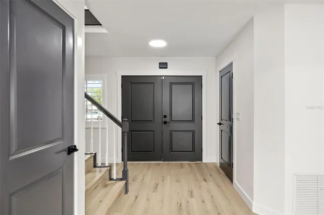 a view of entryway with wooden floor and stairs