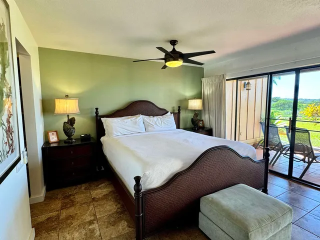 a bedroom with a bed dresser and a window