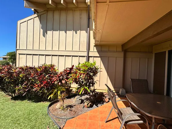 a vase of flowers sitting on a table in front of a window