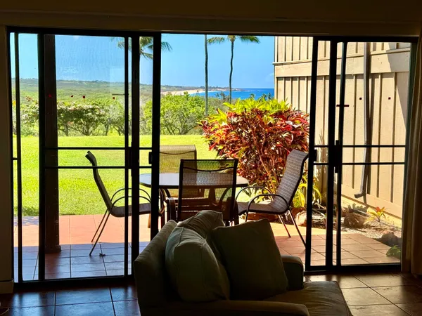swimming pool view from a balcony with seating space