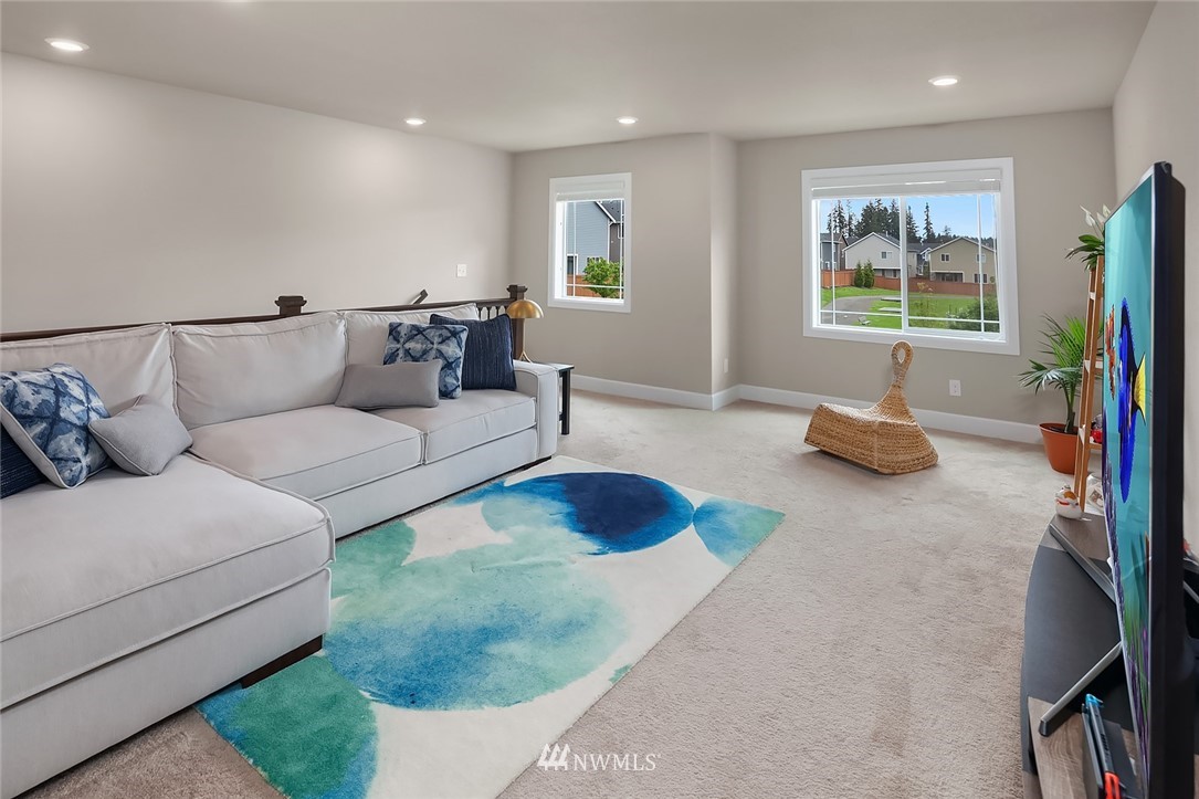 3911 174th Place Southeast Bothell, WA 98012 - Photo 14 of 27 a living room with furniture and a large window