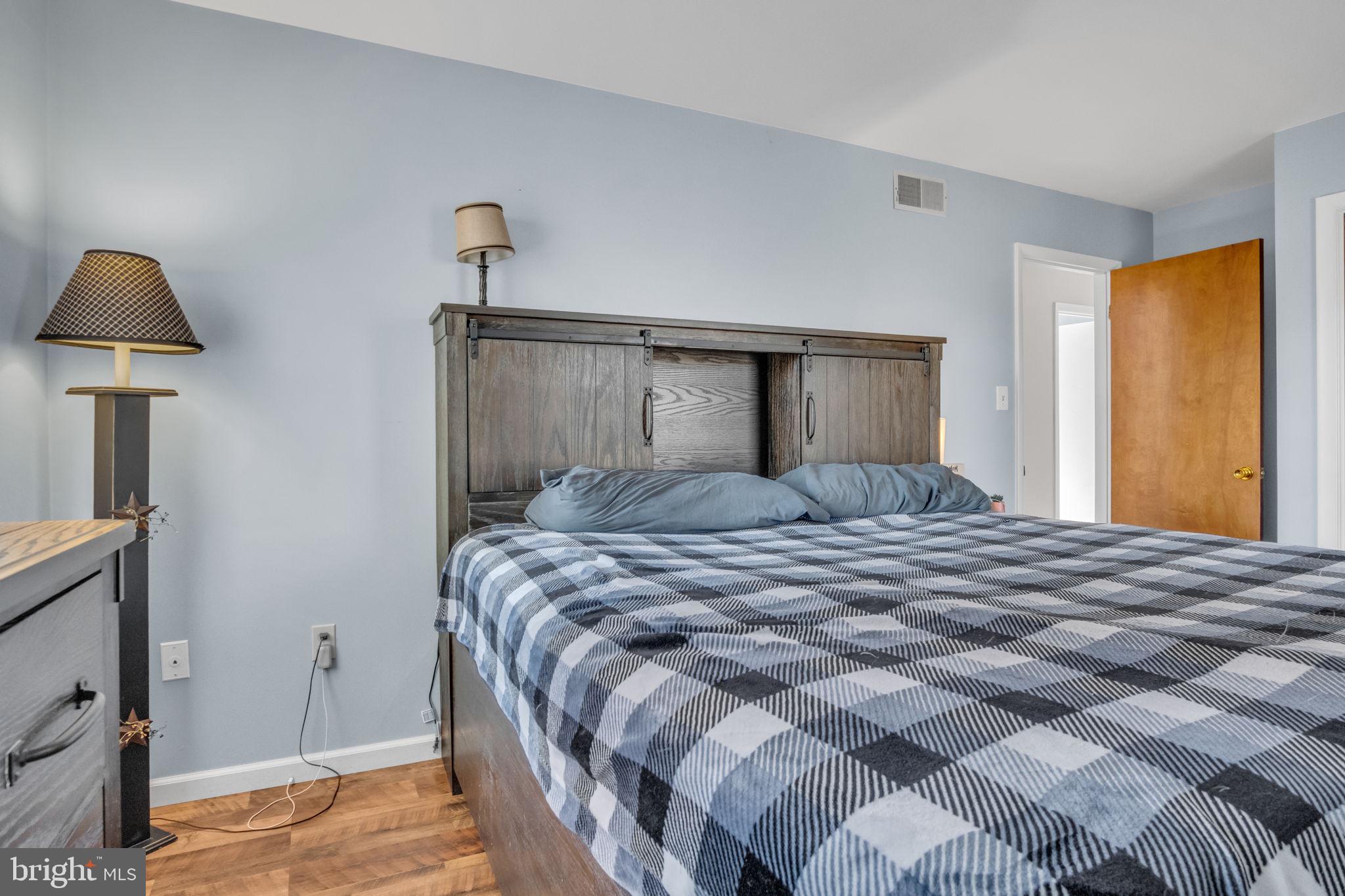 224 Faith Circle Carlisle, PA 17013 - Photo 19 of 32 a bedroom with a bed and a lamp