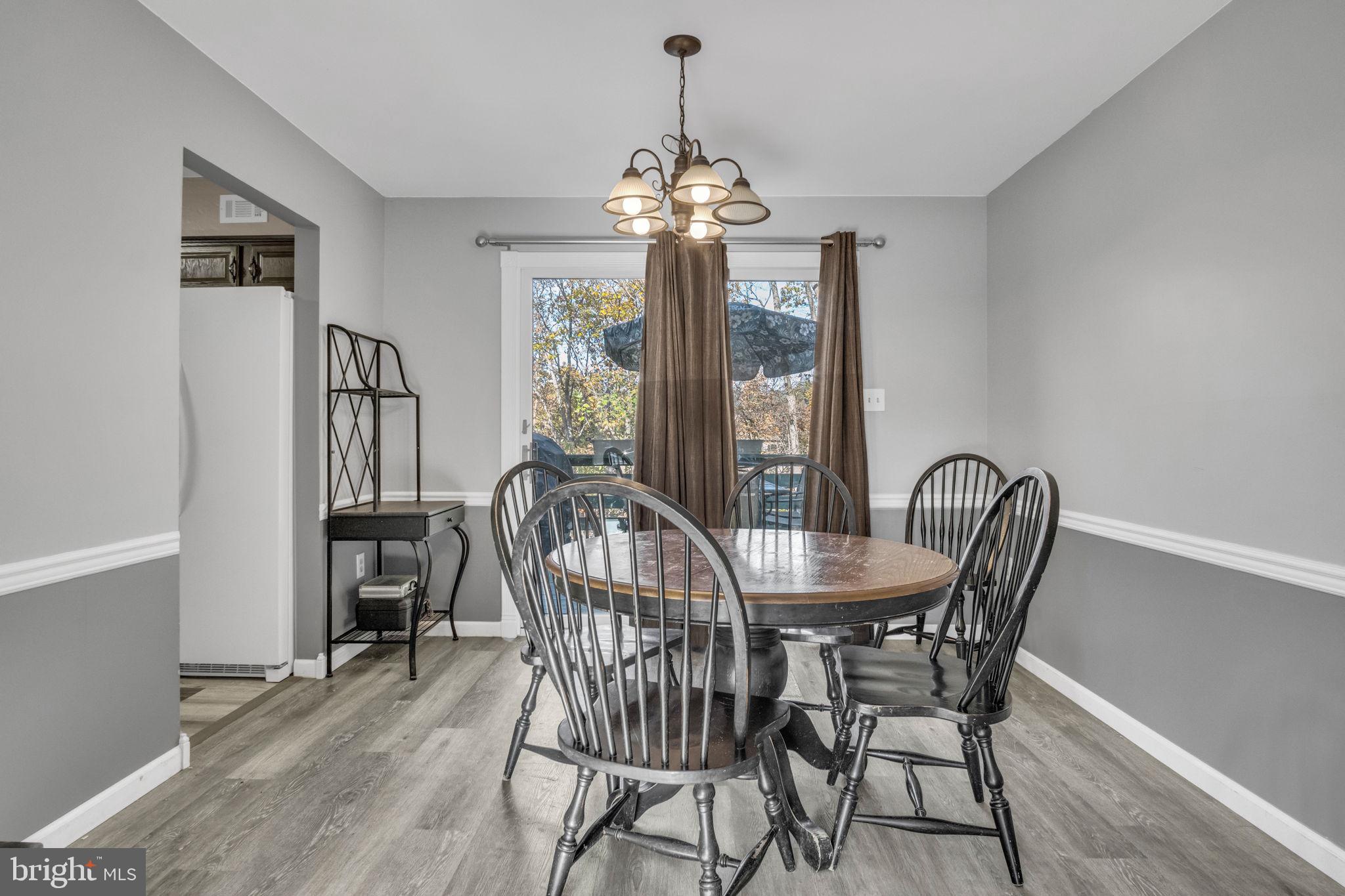 224 Faith Circle Carlisle, PA 17013 - Photo 6 of 32 a dining room with furniture a chandelier and wooden floor