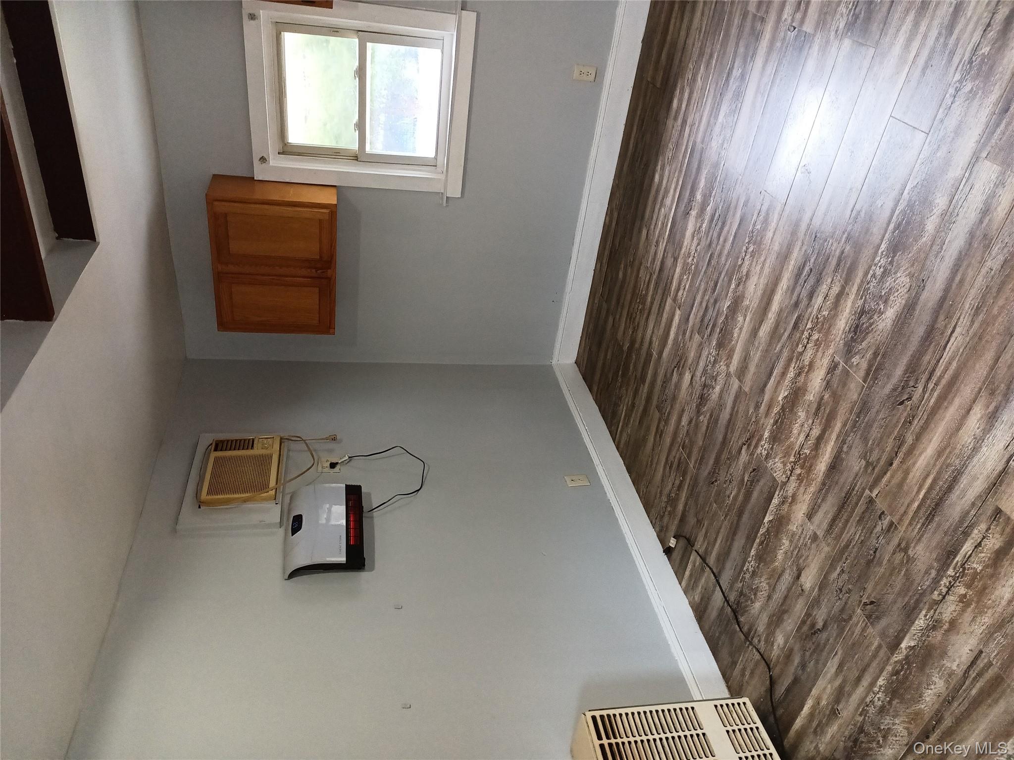 200 Fosler Road, Unit 49 Highland, NY 12528 - Photo 3 of 7 a view of a room with wooden floor and cabinet