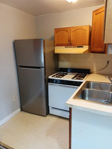 a kitchen with a refrigerator and a sink