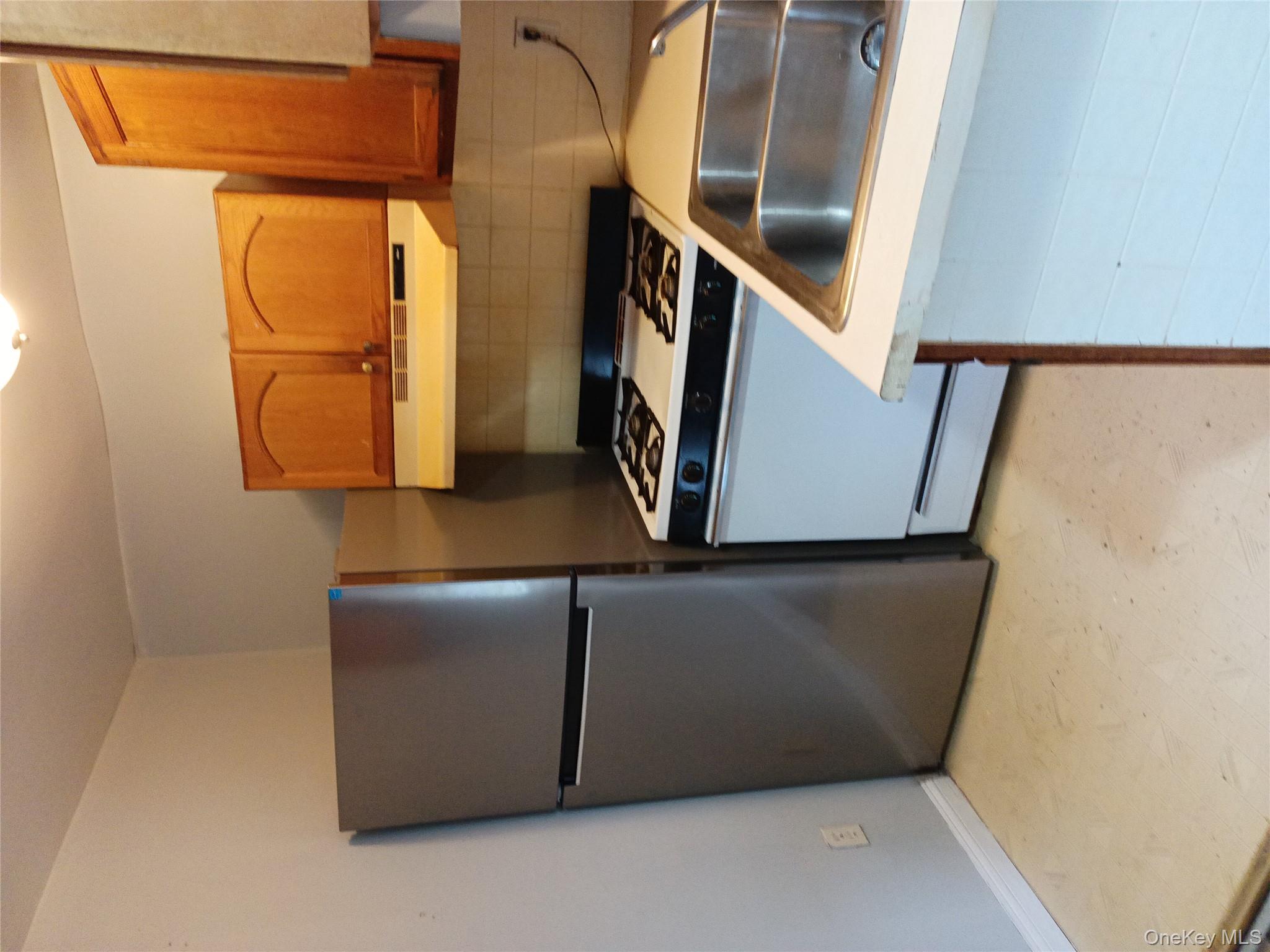 200 Fosler Road, Unit 49 Highland, NY 12528 - Photo 5 of 7 a kitchen with a refrigerator and a sink