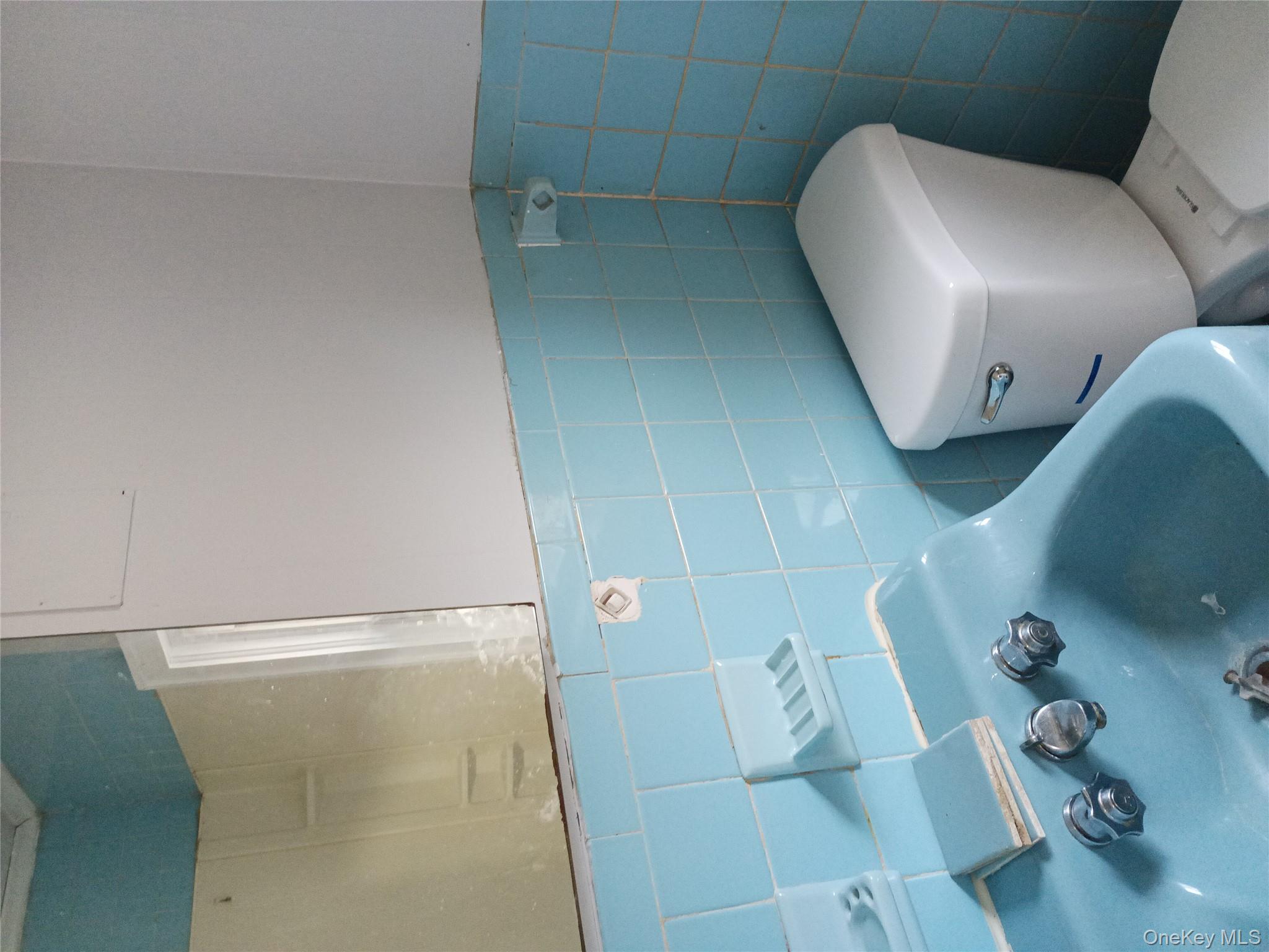 200 Fosler Road, Unit 49 Highland, NY 12528 - Photo 7 of 7 a white toilet sitting next to a bathroom sink