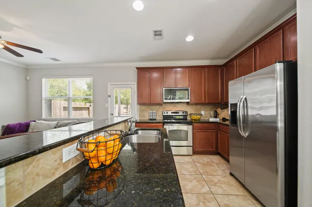 a large kitchen with a table and chairs