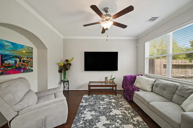 a living room kitchen with furniture and a large window