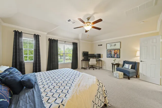 a bedroom with a bed couch and a window