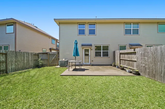 a view of a backyard with a large tree
