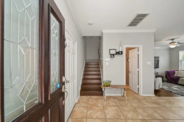 a view of a hallway to rooms and stairs