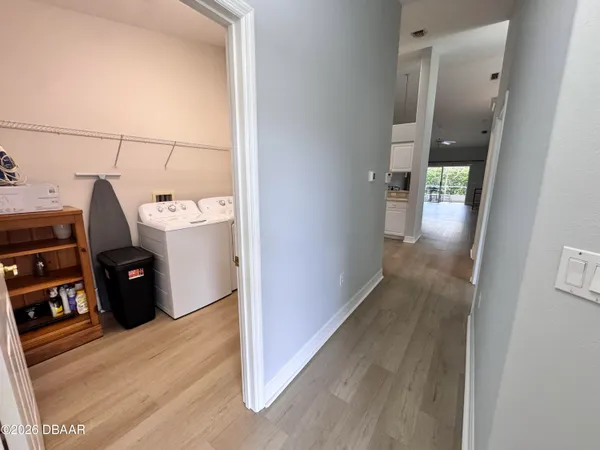 a view of a room with wooden floor and window