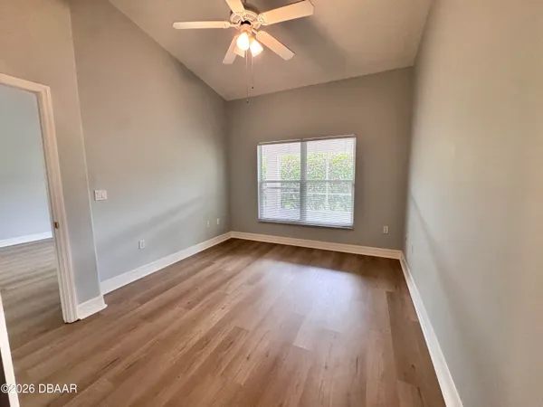 a view of a room with wooden floor