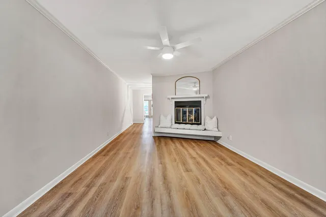 a view of a room with wooden floor and a fireplace