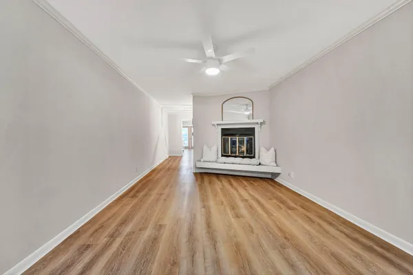 a view of a room with wooden floor and a fireplace