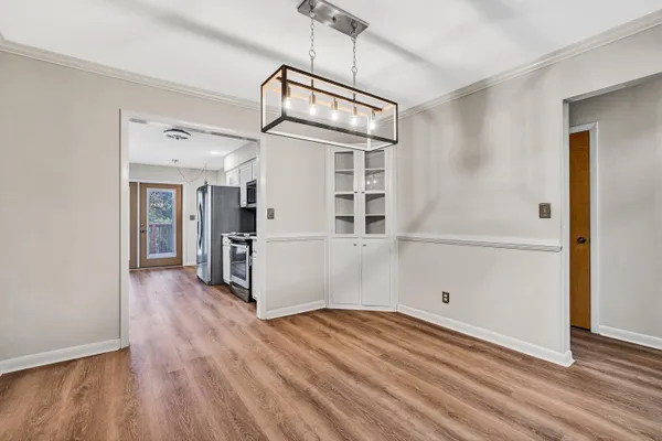 a view of empty room with wooden floor