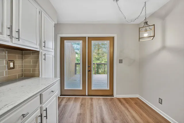 a view of kitchen with granite countertop cabinets and window
