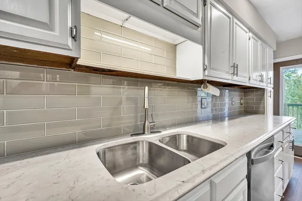a view kitchen with granite countertop a sink and a stove