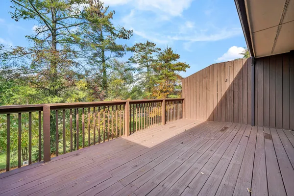 a balcony with wooden floor and fence