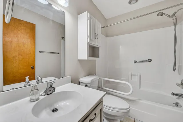 a bathroom with a sink toilet and shower