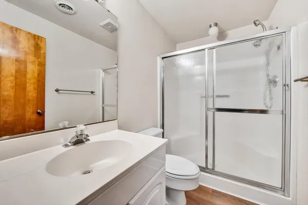 a bathroom with a sink and a mirror with toilet