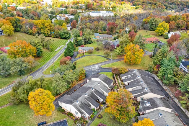 an aerial view of residential house with swimming pool and lawn chairs