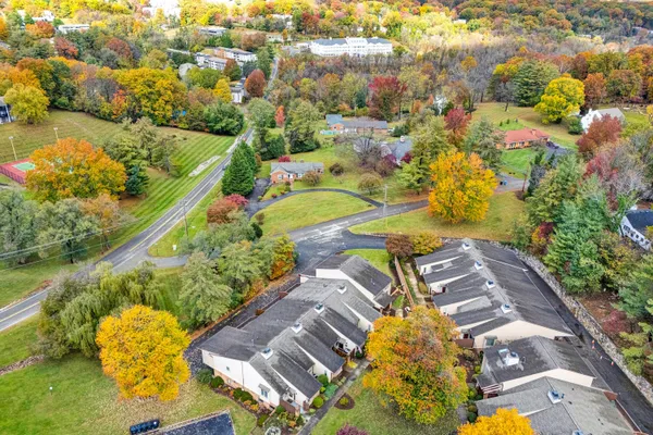 an aerial view of residential house with swimming pool and lawn chairs