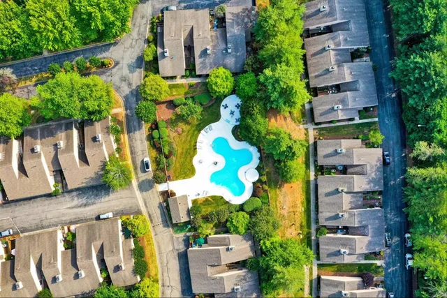 an aerial view of multiple houses with yard