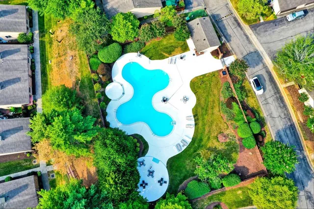an aerial view of a house with a pool and garden