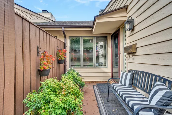 a view of a house with a chairs and table in a balcony