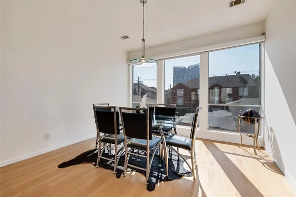 a kitchen with stainless steel appliances granite countertop a sink a stove and a wooden floors